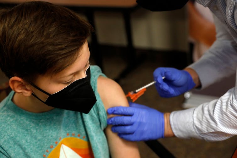 A boy receives a shot