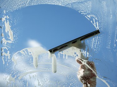 Cleaning a window with a squeegee