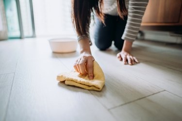 Cropped shot of a young woman cleaning the floor with a cloth at home during the day