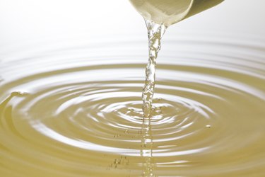 vinegar pouring from a small ramekin into a larger container