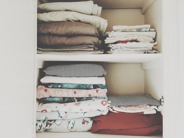 Blankets and sheets stacked on shelves