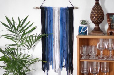 Grab some old t-shirts hanging around in your closet to create an eye-catching and stylish wall hanging.