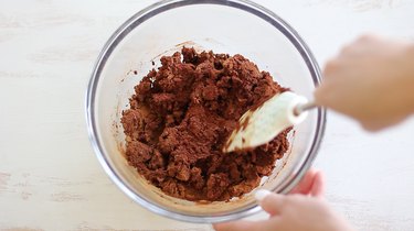 Mixing applesauce, cinnamon and glue in bowl