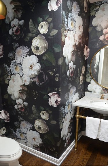 Powder room with bold floral wallpaper