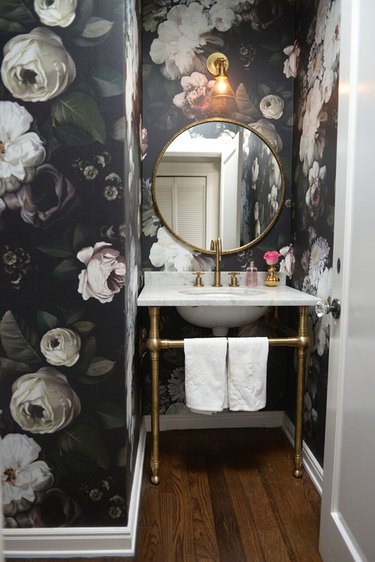 Powder room with bold floral wallpaper