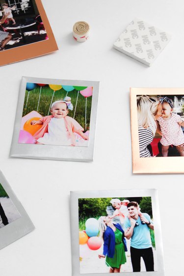 Metallic Polaroid photos on a desk