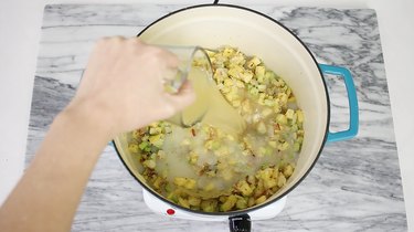 Pouring clam juice into pot