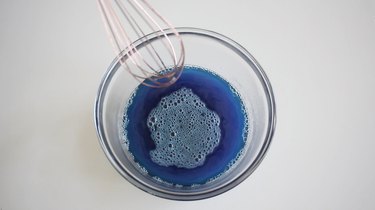 Whisking boiling water with blue Jello mix