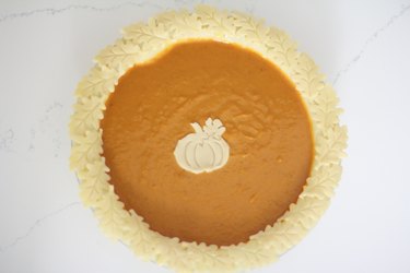 Pie decorated with pumpkin and leaves cutouts