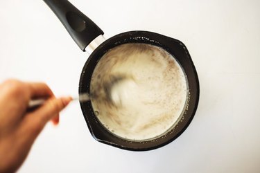 Whisking together the milk and yeast.