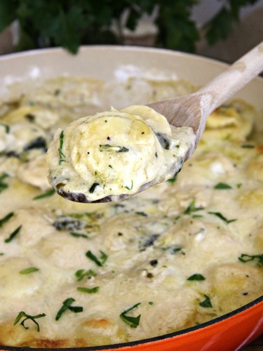 spinach and artichoke ravioli casserole on a spoon