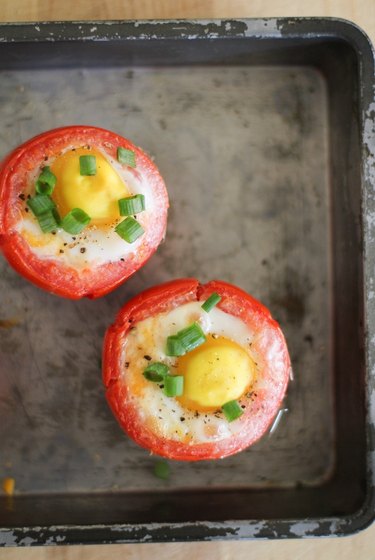 Cooked eggs and tomatoes, topped with chopped green onion.