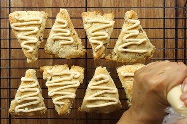 Piping low carb frosting on gluten free scones.
