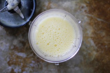 Beaten eggs with hemp seeds in a blender canister.