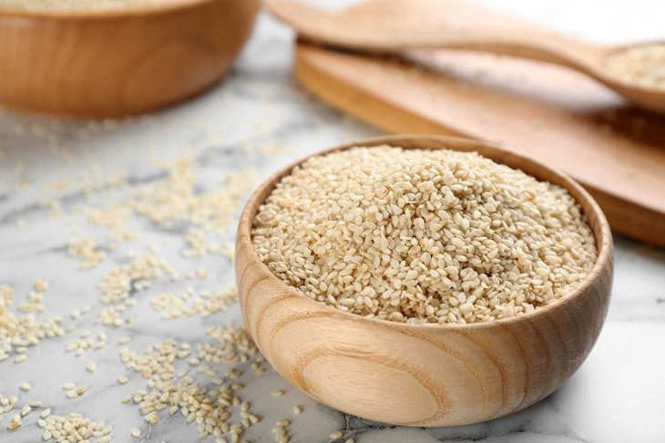 Sesame seeds in bowl on white marble table